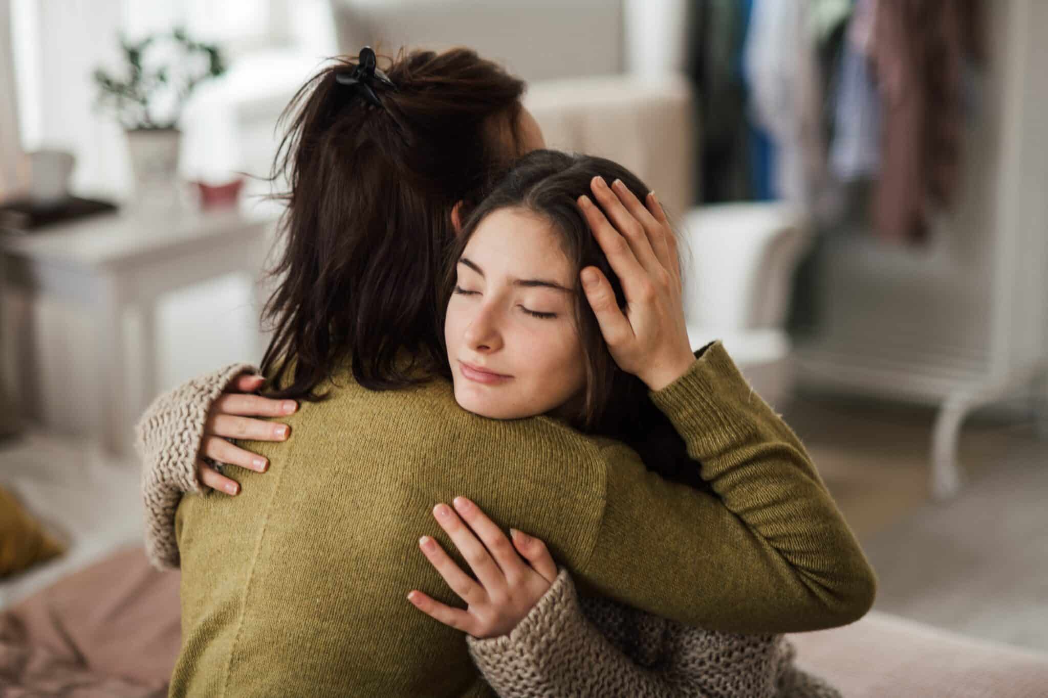 Mum and daughter having a hug as one faces addiction and fighting it